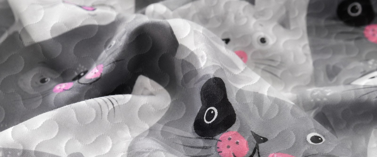 Close-up of soft microfiber polyester fabric and cartoon cat print
